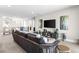 Inviting living room with a comfortable sofa, entertainment center, neutral tones, and a staircase leading to another level at 286 Shaded Canyon Dr, Henderson, NV 89012
