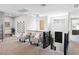 Bright open loft space with two chairs, modern chandelier, large window views, and decoratively painted accent wall at 286 Shaded Canyon Dr, Henderson, NV 89012