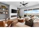 Stylish living room showcasing a linear fireplace, floating shelves, a comfortable sofa, and sliding doors to the outdoor space at 286 Shaded Canyon Dr, Henderson, NV 89012