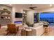 Cozy living room with a modern electric fireplace, floating shelves, comfortable seating, and a view of the backyard at 286 Shaded Canyon Dr, Henderson, NV 89012