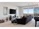 Cozy living room featuring a plush sofa, large-screen TV, sliding glass doors with scenic views, and stylish decor at 286 Shaded Canyon Dr, Henderson, NV 89012
