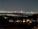Breathtaking night view of city skyline from afar, showcasing illuminated buildings and landscape at 286 Shaded Canyon Dr, Henderson, NV 89012