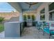 An outdoor kitchen features a built-in grill, refrigeration, and counter seating at 286 Shaded Canyon Dr, Henderson, NV 89012