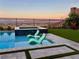 Inviting outdoor pool and spa area with city views and comfortable lounge seating at 286 Shaded Canyon Dr, Henderson, NV 89012