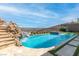 Backyard pool with rock waterfall slide, spa, and comfortable seating at 286 Shaded Canyon Dr, Henderson, NV 89012