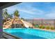 Relaxing pool area showcasing a waterfall feature, slide, and gorgeous city views at 286 Shaded Canyon Dr, Henderson, NV 89012