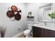 Stylish powder room with modern vanity, elegant fixtures, and decorative wall art at 286 Shaded Canyon Dr, Henderson, NV 89012