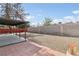 View of the backyard with block wall and covered patio at 3017 Jamestown Way, Las Vegas, NV 89102