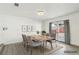 A staged dining room featuring modern furniture, decor, natural light, and access to the backyard through double doors at 3017 Jamestown Way, Las Vegas, NV 89102