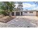 Single-story home featuring a two-car garage, desert landscaping and a gray accent wall at 3017 Jamestown Way, Las Vegas, NV 89102