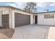 Single-story home featuring a two-car garage, desert landscaping, and a gray accent wall at 3017 Jamestown Way, Las Vegas, NV 89102