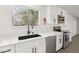 Modern kitchen with stainless steel appliances, white cabinets, and a sleek black sink at 3017 Jamestown Way, Las Vegas, NV 89102