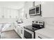 Modern kitchen featuring white countertops, cabinets, stainless steel appliances, and a contemporary sink at 3017 Jamestown Way, Las Vegas, NV 89102