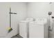 Laundry room features a washer and dryer, and wall mounted broom at 3017 Jamestown Way, Las Vegas, NV 89102