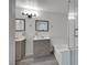 A well-lit bathroom features a tub, shower, and dual sink vanities with mirrors at 3404 Winterhaven St # 204, Las Vegas, NV 89108