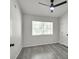 This is a bedroom featuring modern ceiling fan, gray wood flooring, and bright window view at 3404 Winterhaven St # 204, Las Vegas, NV 89108