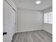 This is a spacious bedroom with gray wood flooring, white walls, and sliding closet doors at 3404 Winterhaven St # 204, Las Vegas, NV 89108