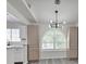 Dining area with modern light fixture, ample cabinets and arched window at 3404 Winterhaven St # 204, Las Vegas, NV 89108