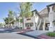 Inviting multi-story condo building with stone accents, red trim, and lush landscaping, providing curb appeal at 3404 Winterhaven St # 204, Las Vegas, NV 89108