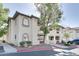 Well-maintained condo building with arched windows, stone details, a red trim, and mature landscaping at 3404 Winterhaven St # 204, Las Vegas, NV 89108