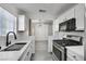 Bright kitchen with modern appliances, white cabinets, and view to living area at 3404 Winterhaven St # 204, Las Vegas, NV 89108