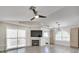 Bright living room features a fireplace, large windows, ceiling fan, and wood flooring at 3404 Winterhaven St # 204, Las Vegas, NV 89108
