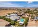 Expansive property with a pool, spa, outdoor kitchen, lush landscaping, and mountain views in the distance at 3458 W Agate Ave, Las Vegas, NV 89139