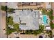An overhead view of an estate showing the roofline, patio, backyard pool and manicured grounds at 3458 W Agate Ave, Las Vegas, NV 89139