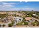 Wide aerial shot showcasing a neighborhood and a beautiful home with landscaped yard and desert surroundings at 3458 W Agate Ave, Las Vegas, NV 89139