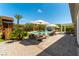 Beautiful backyard oasis with pool, lounge seating, patio, manicured lawn, and outdoor play area at 3458 W Agate Ave, Las Vegas, NV 89139