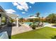 Lush backyard with pool, lounge chairs, pergola, play area, and well-maintained lawn at 3458 W Agate Ave, Las Vegas, NV 89139