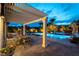 Outdoor dining area with large table under a pergola with a built in spa and pool at 3458 W Agate Ave, Las Vegas, NV 89139
