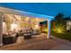 Covered outdoor seating area with plush seating, kitchenette, and soft lighting at 3458 W Agate Ave, Las Vegas, NV 89139