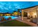 Inviting backyard with pool, spa, and outdoor seating area, illuminated at twilight at 3458 W Agate Ave, Las Vegas, NV 89139