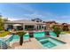 Resort-style backyard with a pool, spa, outdoor seating, lush landscaping, and a play area at 3458 W Agate Ave, Las Vegas, NV 89139