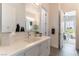 This bathroom features a single sink vanity with quartz counters and views to a play room at 3458 W Agate Ave, Las Vegas, NV 89139