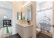 Cozy bathroom with single vanity sink, grey tile flooring and a bathtub shower combo at 3458 W Agate Ave, Las Vegas, NV 89139