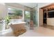 Bright bathroom features a soaking tub, a glass shower and a walk-in closet for all your needs at 3458 W Agate Ave, Las Vegas, NV 89139