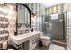 Eye-catching bathroom featuring modern fixtures, patterned wallpaper, and walk-in shower at 3458 W Agate Ave, Las Vegas, NV 89139