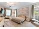 Relaxing bedroom showcasing large bed, sitting area, and natural light at 3458 W Agate Ave, Las Vegas, NV 89139