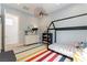 This bedroom features unique bed frame, a colorful rug, and designer lighting at 3458 W Agate Ave, Las Vegas, NV 89139