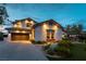A lovely single-Gathering home with a beautiful lawn and landscaping, lit in the evening at 3458 W Agate Ave, Las Vegas, NV 89139
