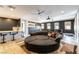 Entertainment space with projector and screen, circular couch, bar, and multiple ceiling fans at 3458 W Agate Ave, Las Vegas, NV 89139
