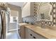 Stylish laundry room featuring patterned wallpaper, sink, countertop space, and modern washer and dryer at 3458 W Agate Ave, Las Vegas, NV 89139