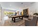 Spacious living room featuring a pool table, contemporary furniture, and ample natural light at 3458 W Agate Ave, Las Vegas, NV 89139
