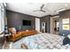 Comfortable main bedroom with unique decor, dark walls, ceiling fan and seating area at 3458 W Agate Ave, Las Vegas, NV 89139