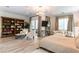 This primary bedroom features a sitting area with a bookshelf and a sofa under a designer lighting fixture at 3458 W Agate Ave, Las Vegas, NV 89139