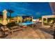 Inviting backyard oasis with a sparkling pool, lush landscaping, and ample seating areas for outdoor entertaining at 3458 W Agate Ave, Las Vegas, NV 89139
