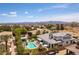 Beautiful backyard with pool, manicured landscaping, a covered patio and mountain views at 3458 W Agate Ave, Las Vegas, NV 89139