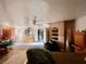 Large bedroom with fan, dresser, closet, and doorway to another room at 3491 S Bridle Way, Crystal, NV 89020